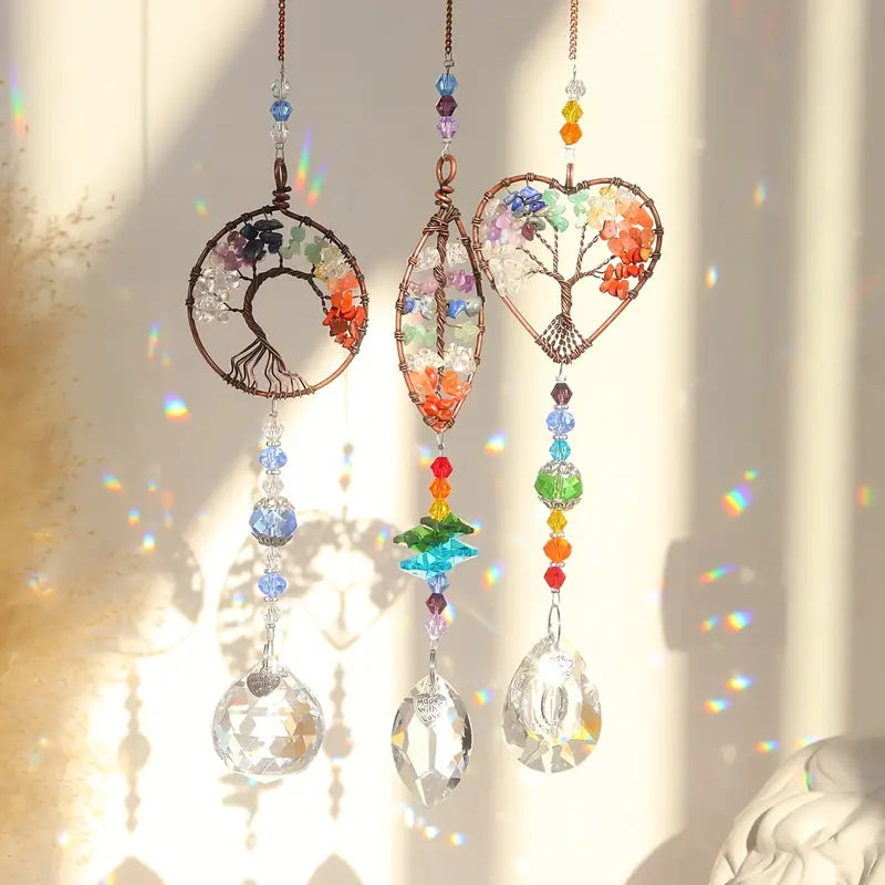 All three Crystal sun-catcher Tree of Life with rainbow prisms hanging in window