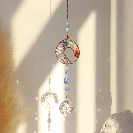 Round Crystal sun-catcher Tree of Life with rainbow prisms hanging by the window